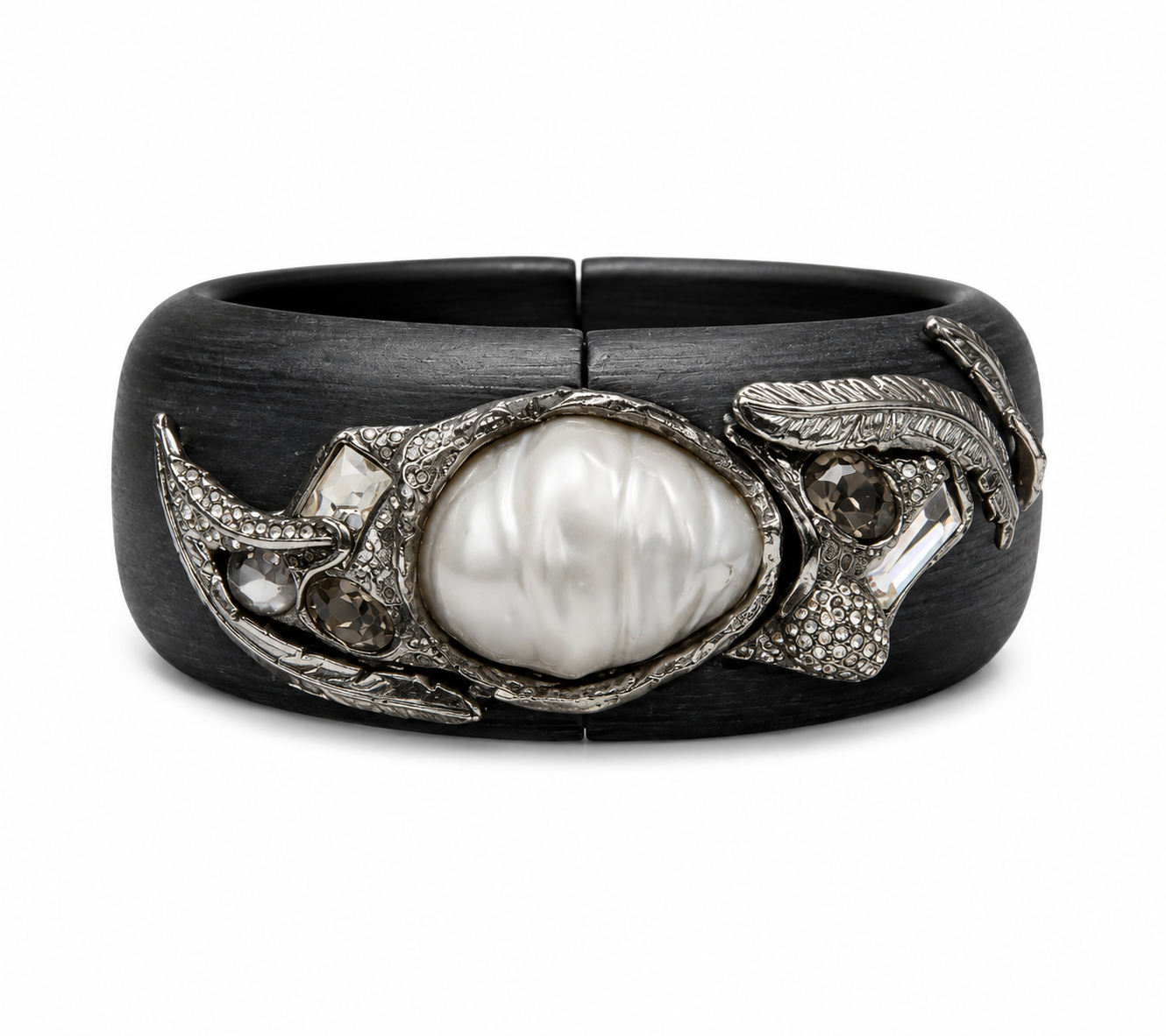 A wide black cuff bracelet featuring a central white pearl surrounded by textured silver-toned metal and small clear stones, shown on a plain white background.