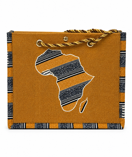 A mustard yellow canvas tote bag featuring a large embroidered silhouette of Africa with black and white patterned stripes, a matching patterned border, and a braided yellow and black rope handle.