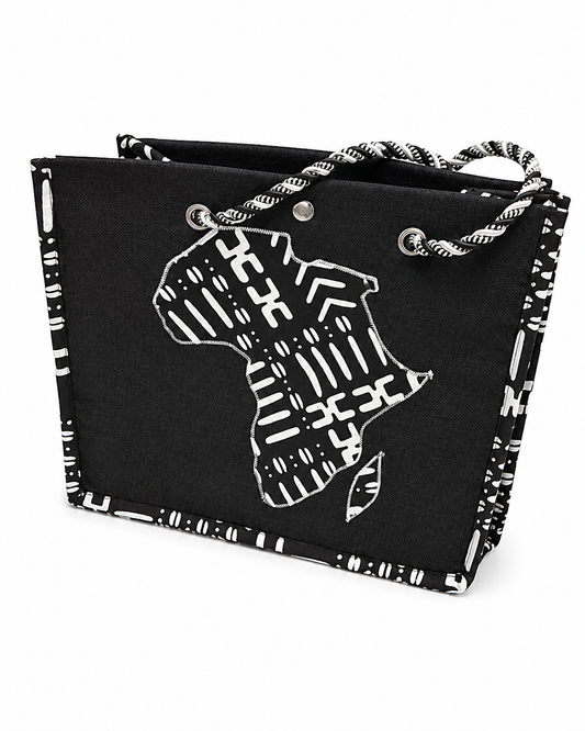 A black canvas tote bag with a white patterned border, rope handles, and a white graphic silhouette of Africa on the front, shown on a plain white background.