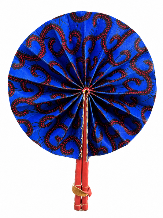 A traditional folding hand fan with a vibrant blue fabric canopy featuring a red and black paisley pattern, attached to a red bamboo handle wrapped with a beige cord.