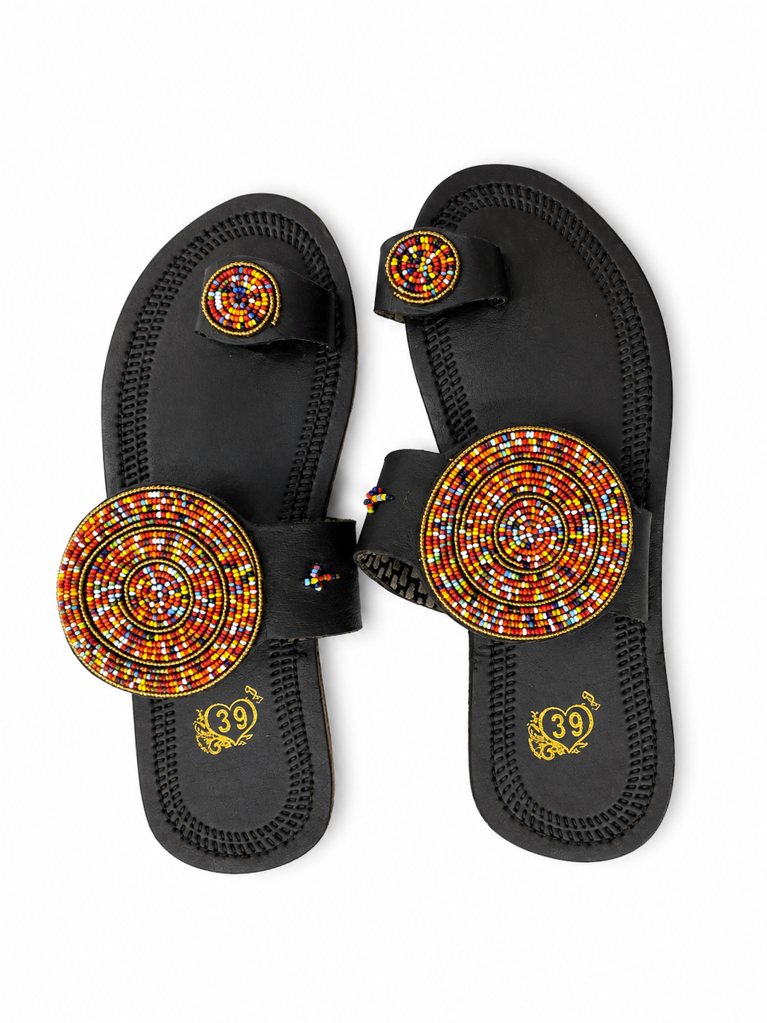 A pair of black thong sandals with large circular beaded toe straps in red, yellow, and white, and matching beaded toe rings, shown on a white background.