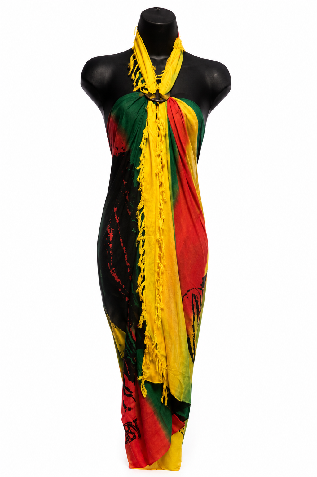 A multicolor halter wrap dress or sarong with fringe, displayed on a black mannequin torso. The fabric features a bold pattern of yellow, red, green, and black.
