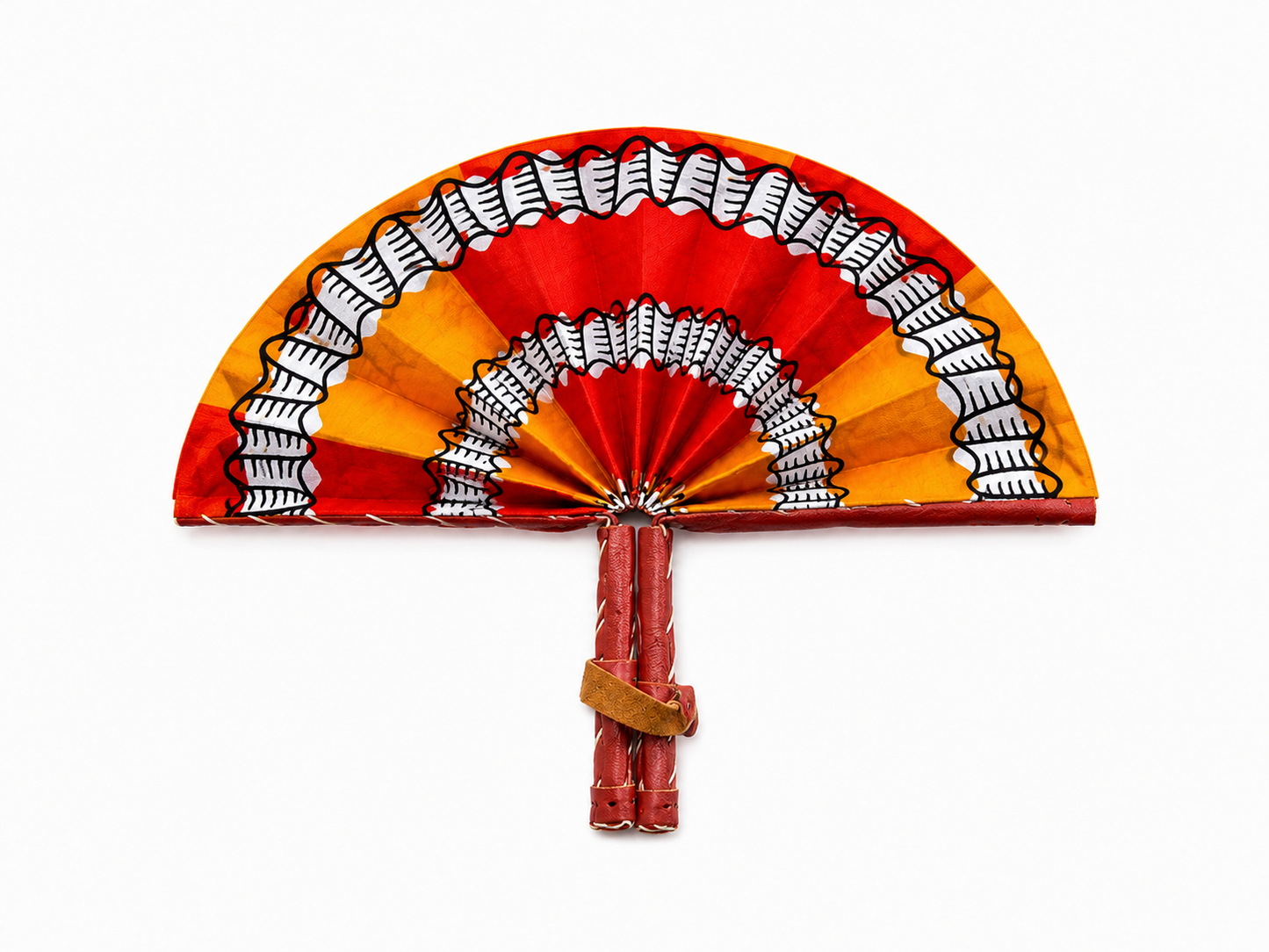 A traditional African hand fan with a red, orange, and yellow waxed cotton fabric pattern, featuring black and white geometric accents, shown on a plain white background.