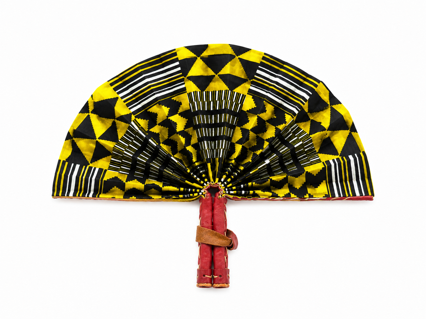 A traditional folding hand fan with a vibrant yellow, black, and white geometric pattern, featuring a red fabric handle wrapped with a brown leather strap, set against a plain white background.